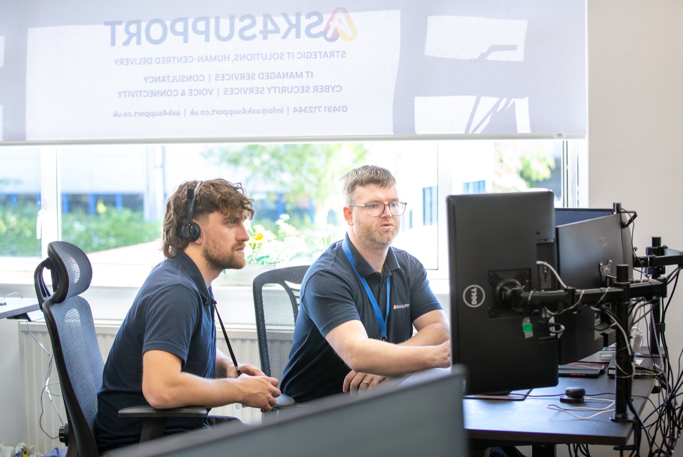 Two Ask4Support engineers working through a problem together